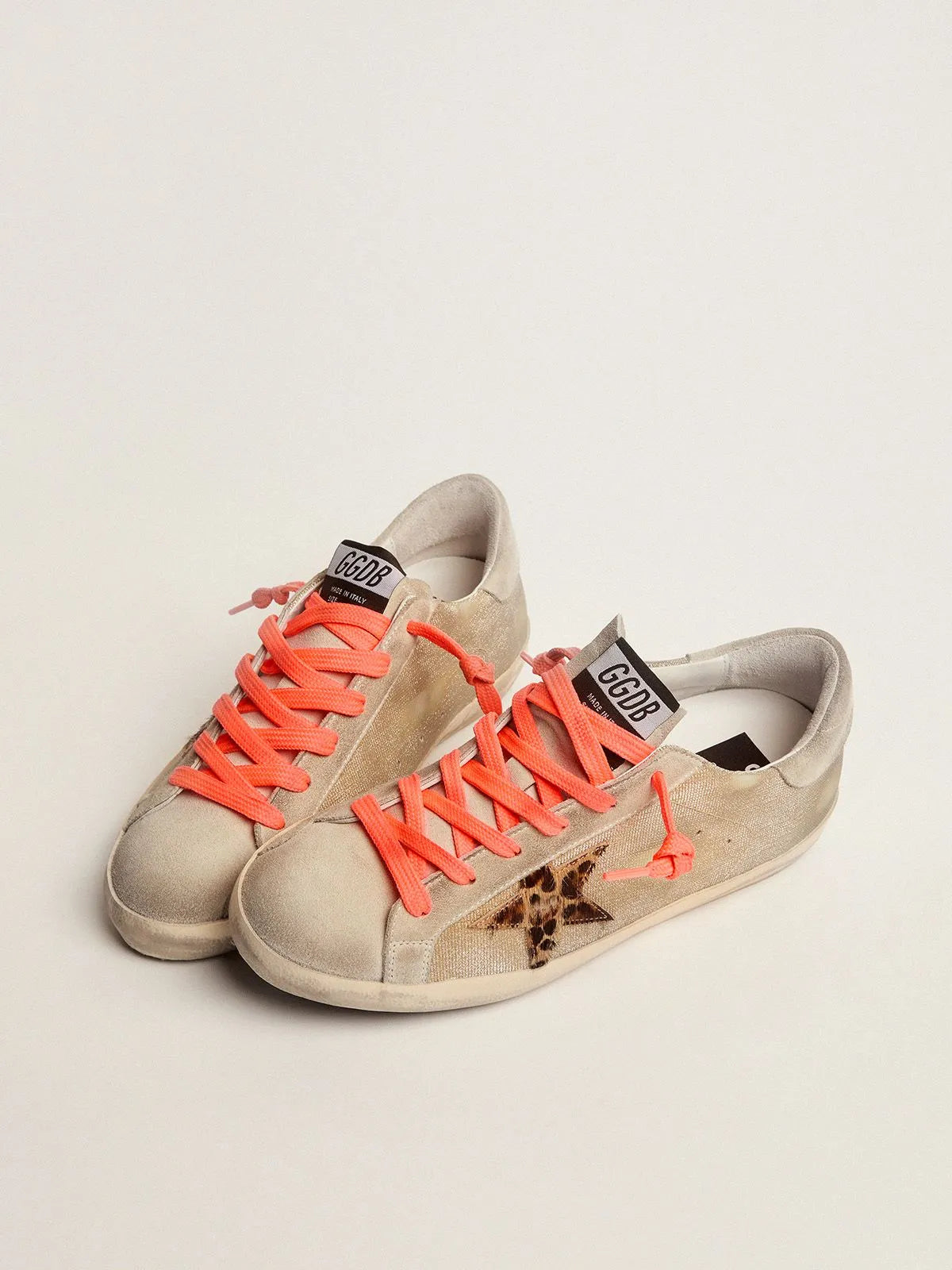 Golden Super-Star sneakers with checkered pattern and hand lettering on the foxing