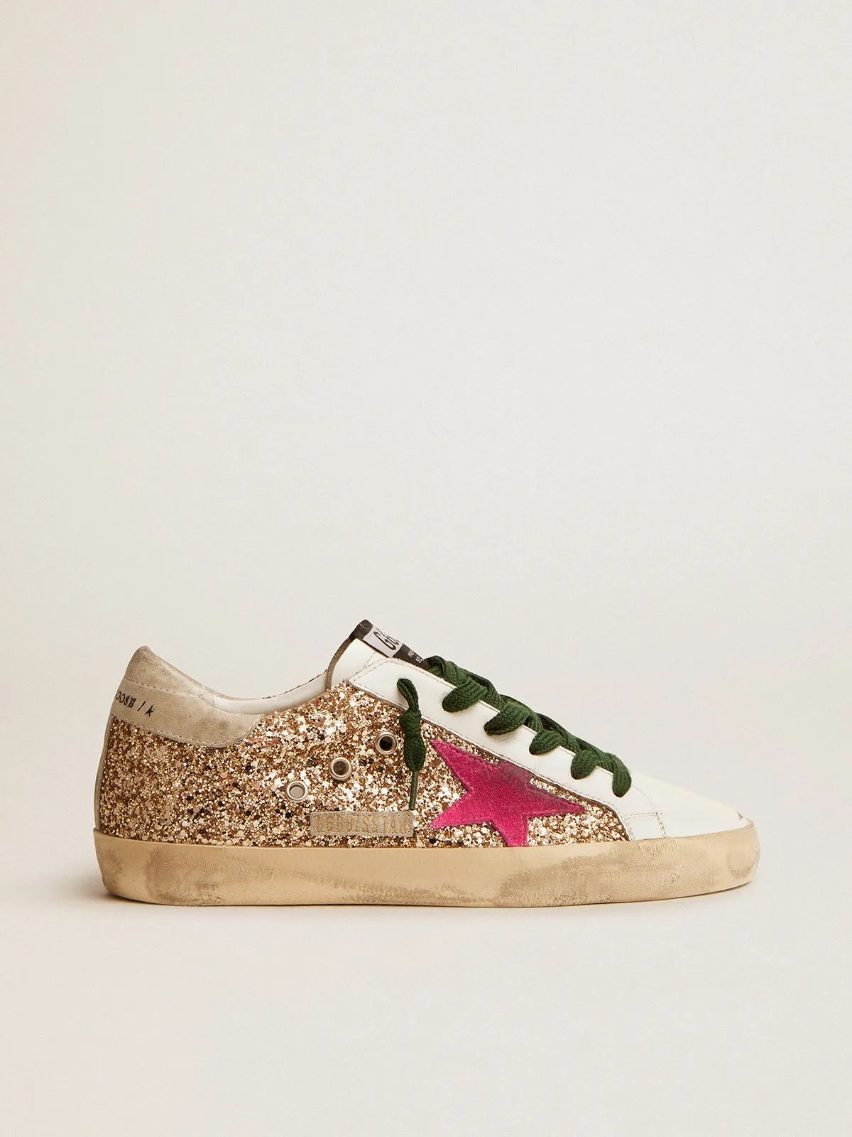 Sneakers Super-Star in glitter oro con stella in camoscio rosa fluo